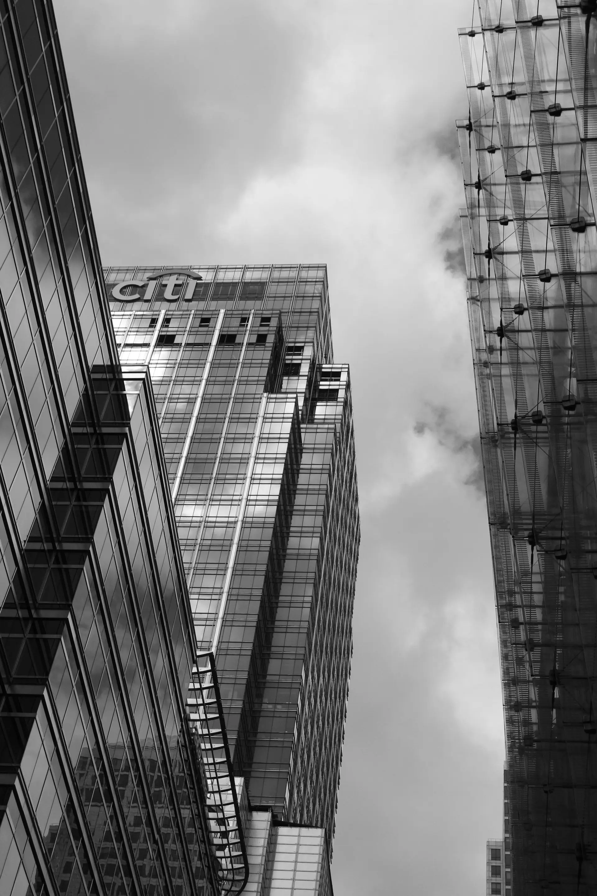 Black-and-white view up the facades of modern office towers