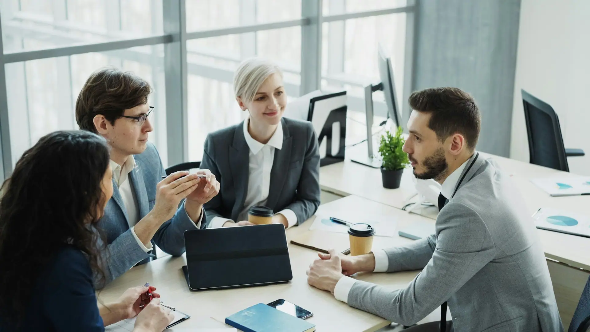 Business professionals in discussion around a meeting table