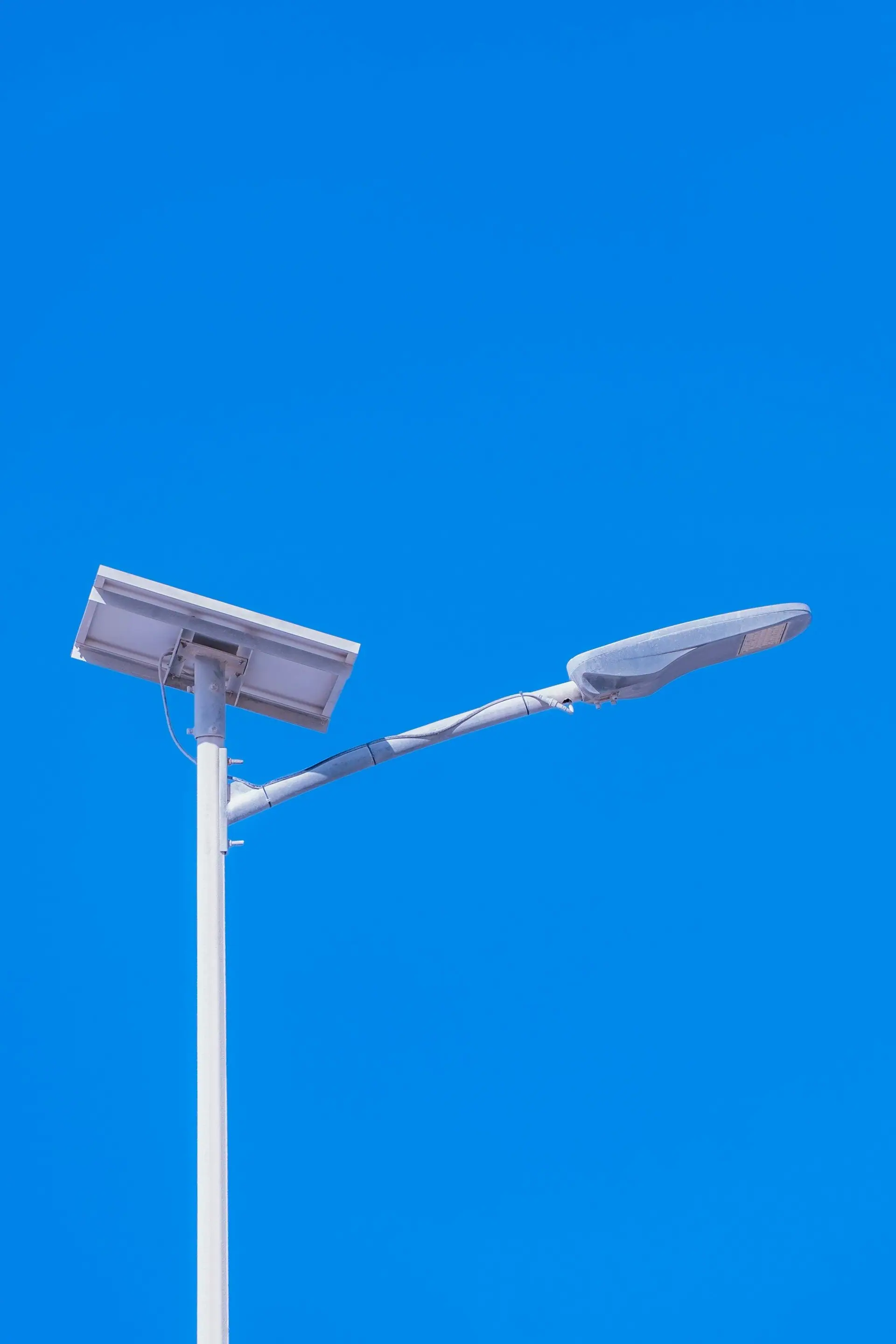 Solar street light with LED luminaire on a slender pole
