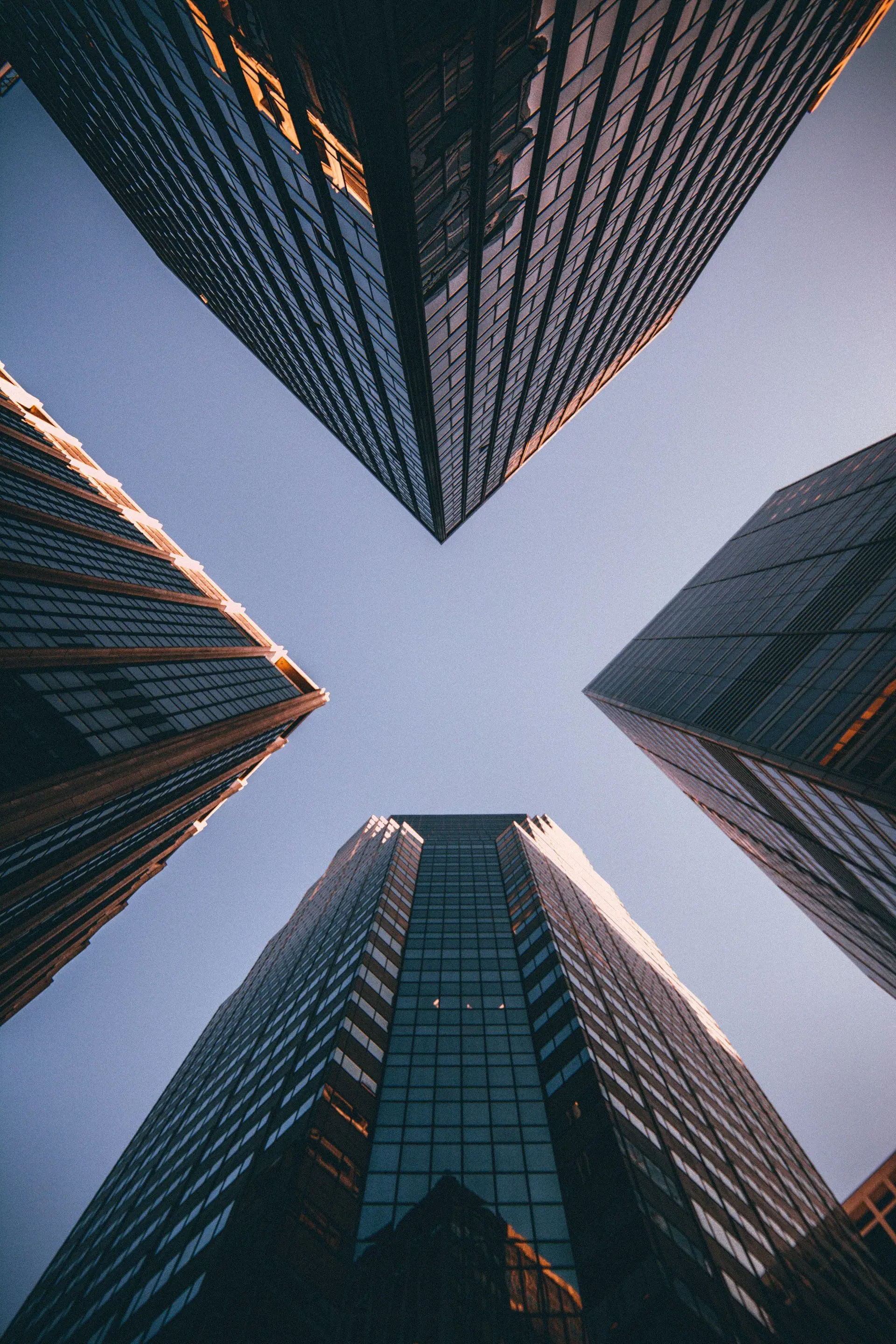 Looking up between glass office towers